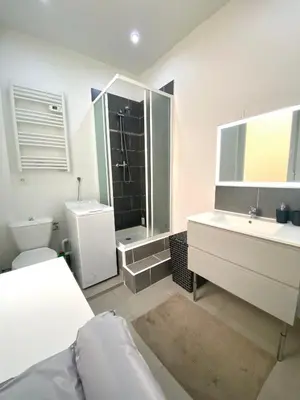 Un ou plusieurs lits dans un hébergement de l'établissement Suite Romain, appartement en centre ville