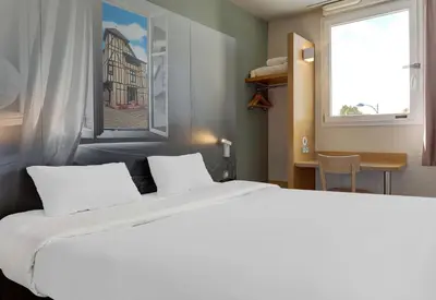 Un ou plusieurs lits dans un hébergement de l'établissement B&B HOTEL Châlons-en-Champagne