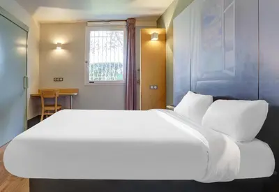 Un ou plusieurs lits dans un hébergement de l'établissement B&B HOTEL Châlons-en-Champagne