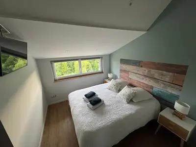 Un ou plusieurs lits dans un hébergement de l'établissement Le Relais de la Fontaine & Jacuzzi