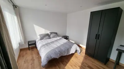 Un ou plusieurs lits dans un hébergement de l'établissement Le petit Château Avesnois - Studio en rez-de-chaussée
