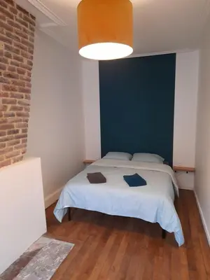 Un ou plusieurs lits dans un hébergement de l'établissement Appartement Atypique